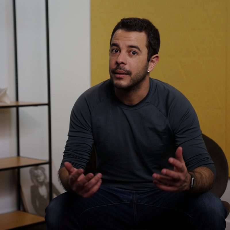 Pablo mid-sentence, hands open, talking through an idea.